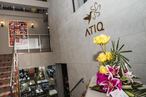 a bouquet of yellow roses in front of a nita store at Atiq Boutique Hotel in Cusco