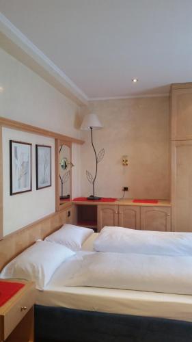 a bedroom with two beds and a table at Chalet Belvedere in Arabba