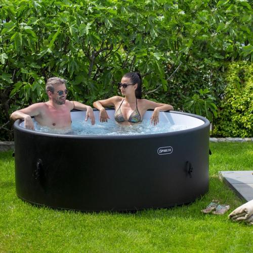 a man and a woman sitting in a hot tub at Your Dream on Lake Maggiore: Historic House e Private Jacuzzi in Stresa