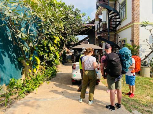 a group of people standing outside of a building at Sophat Villa in Siem Reap