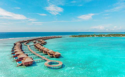 a resort in the ocean with chairs and an island at Hideaway Beach Resort & Spa, FREE SHARED CHARTER FLIGHT for two on stays of 7 or more nights from September 2025 until 23rd December 2026 in Dhidhdhoo