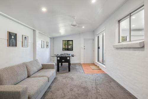 a living room with a couch and a table at Eastside Haven - Central & Convenient! in Toowoomba