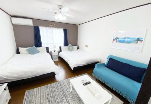 a living room with two beds and a couch at Flat piece chair house - Vacation STAY 40368v in Fuzuchi