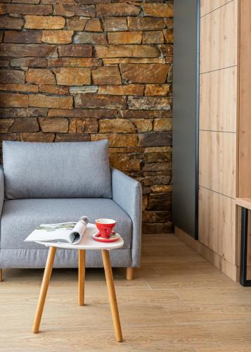 a living room with a couch and a coffee table at Хотел Камъните in Burgas