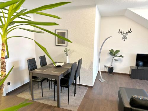 a dining room with a black table and chairs at Ferienwohnung Augenblick - Stylisches Apartment in der besten Altstadtlage von Erfurt in Erfurt