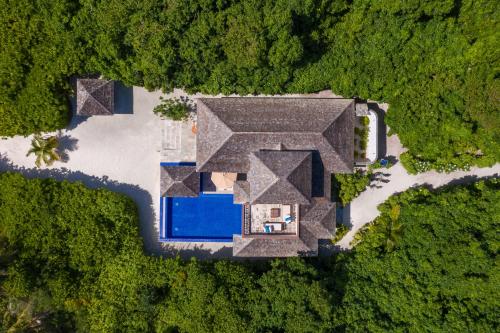 an overhead view of a house with a swimming pool at Hideaway Beach Resort & Spa, FREE SHARED CHARTER FLIGHT for two on stays of 7 or more nights from September 2025 until 23rd December 2026 in Dhidhdhoo