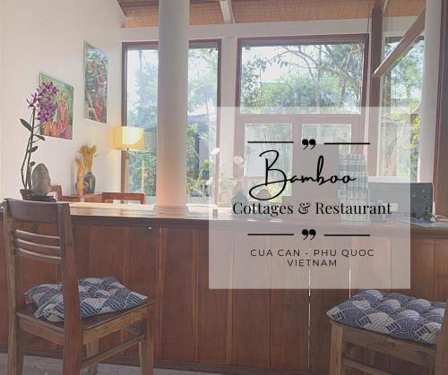 a salon counter with two chairs and a window at Bamboo Cottages in Phu Quoc