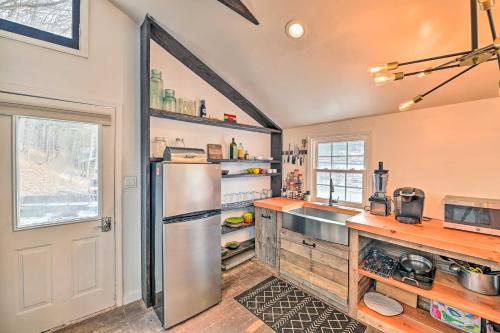a kitchen with a stainless steel refrigerator and wooden counters at Chic Prattsville Studio with Private Hot Tub! in Prattsville