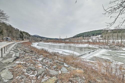 a river with snow on the side of it at Chic Prattsville Studio with Private Hot Tub! in Prattsville