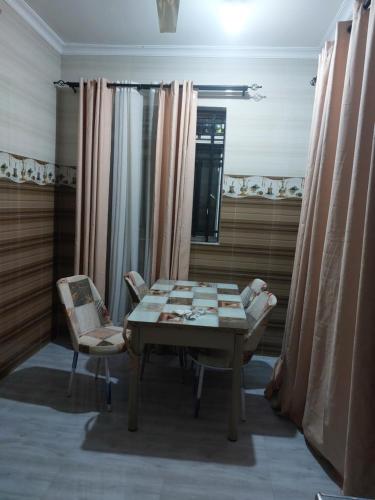 a dining room with a table and two chairs at Nungwi appartement- house in Nungwi