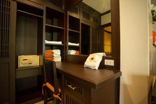 a kitchen with a wooden counter with a mirror at Am Samui Palace in Lamai