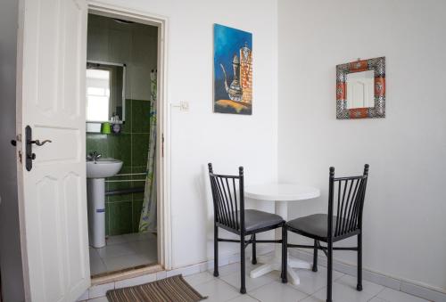 a dining room with a table and two chairs at Auberge Sable D'Or in Sidi Ifni