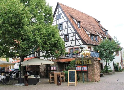a hotel with a hotel sign in front of a building at Altes Badhaus in Eberbach
