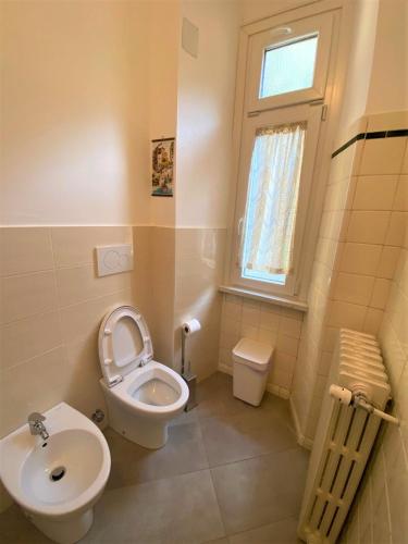 a bathroom with a toilet and a sink at Villa Silvana in Perledo