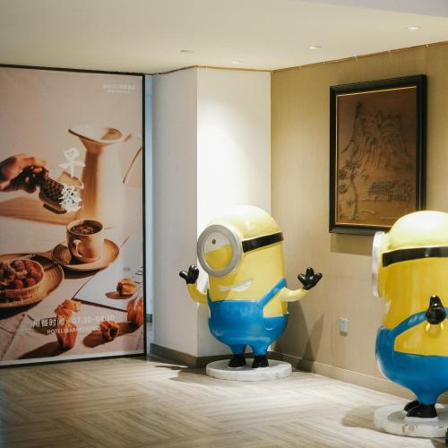 a room with a statue of a minion on display at Chengdu Prolit Hotel in Chengdu