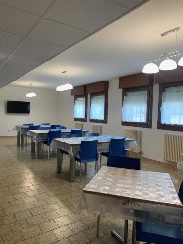 a conference room with tables and blue chairs at Casa Vacanze Paolo VI in Padova