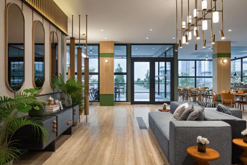 a living room with a couch and a table at MaxOneHotels at Kota Harapan Indah-Bekasi in Bekasi