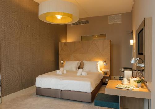 a hotel room with a bed and a lamp at Amadi Panorama Hotel in Amsterdam