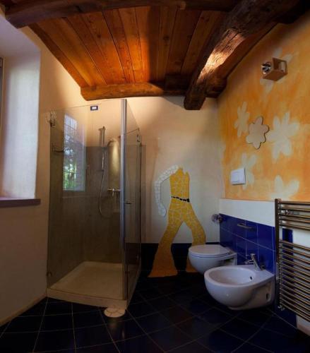 a bathroom with a shower and a toilet and a sink at LA CASETTA NEI COLLI in Bergamo