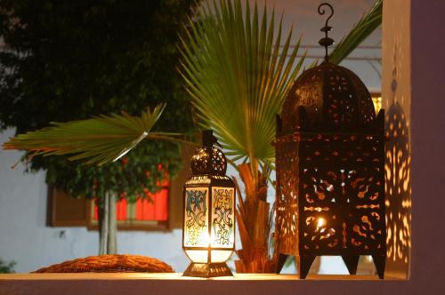 a lantern sitting on a table with a plant at Dar Omar Khayam in Tangier