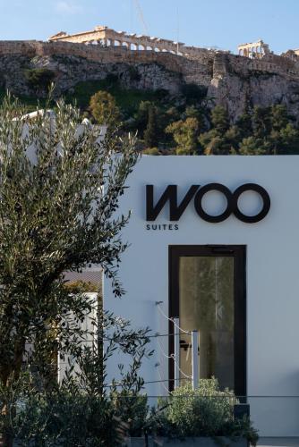 a woco sign on the side of a building at Athens Woo Suites in Athens