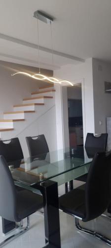 an office with a glass table and chairs at Apartmani Lanterna in Krk