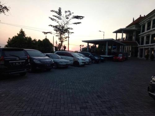a group of cars parked in a parking lot at Avila Ketapan Rame Hotel in Trawas