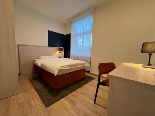 a small room with a bed and a window at Dialoghotel Eckstein in Zug