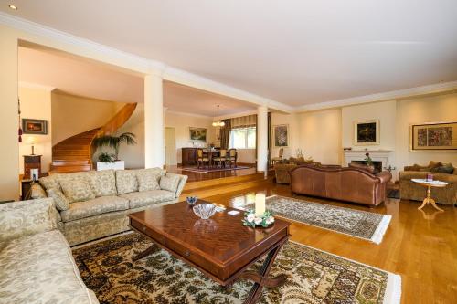 a living room with couches and a coffee table at Supreme and Classy Pool Residence in Paianía