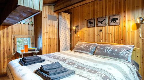 a bedroom with a bed with towels on it at Chalet Monti Della Luna 7, Emma Villas in Bousson