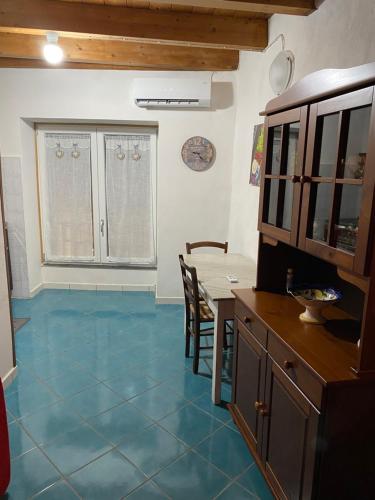 a kitchen with a blue tile floor and a table at da paola in Iglesias