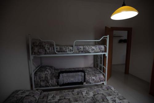 a bedroom with a bunk bed and a light at Bilocale Camilla in villa salento in Sant'Isidoro