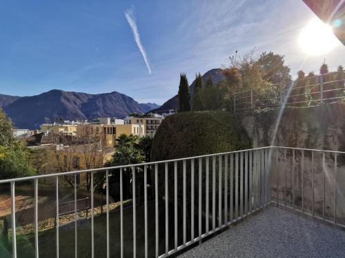 a balcony with a fence and mountains in the background at Experience The Loft! LOFT 18, downtown, near the lake FREE PARKING available in Lugano