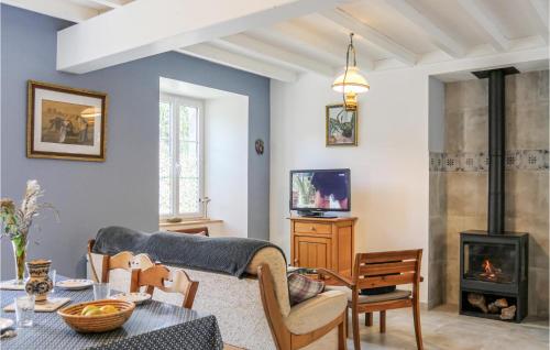 a living room with a couch and a fireplace at La Petite Mainnerie in Jobourg
