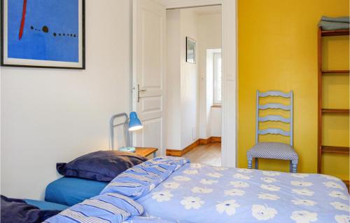 a bedroom with a bed and a chair in it at La Petite Mainnerie in Omonville-la-Petite