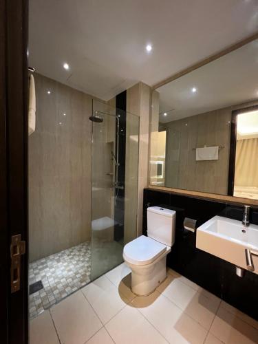 a bathroom with a toilet and a shower and a sink at MIO BOUTIQUE Hotel in Melaka
