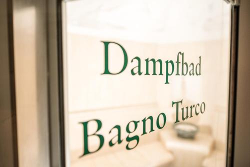a sign in a window of a barona tounge at Lodenwirt Residence in Vandoies