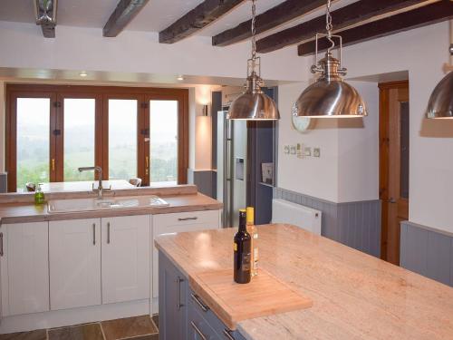 a kitchen with a counter with a bottle of wine on it at Cote Farm in Langsett