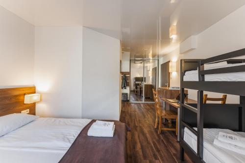 a bedroom with two bunk beds and a desk at Apartamenty Eko in Szczawnica