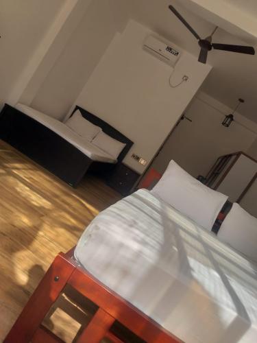 a small room with a bed and a couch at The Blue Lagoon Resort Kalpitiya in Kalpitiya
