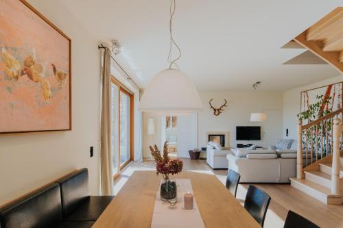 a living room with a dining table and a couch at Hof Niglberg Südsteiermark in Sankt Johann im Saggautal