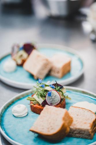 two blue plates of food on a table at Lodenwirt Residence in Vandoies
