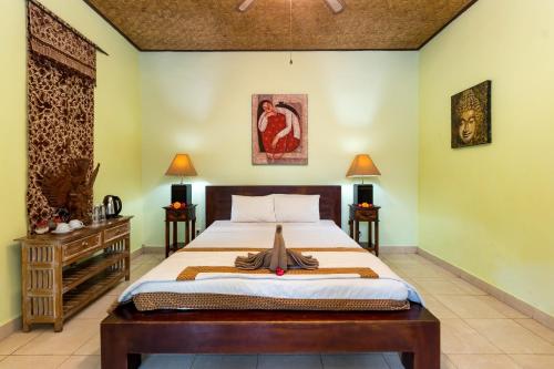 a bedroom with a bed and two night stands at The Tunjung Ubud Retreat in Ubud