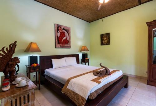 a bedroom with a bed in a room with green walls at The Tunjung Ubud Retreat in Ubud