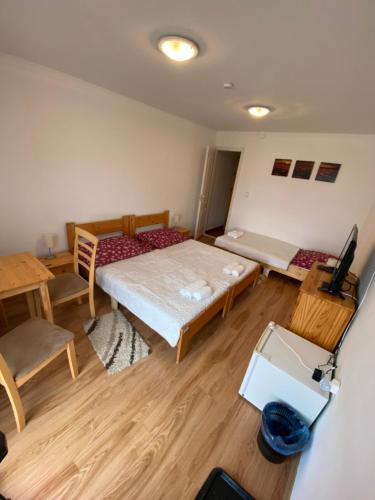 a room with a bed and a table and chairs at Aranyló Vendégház in Alsótelekes