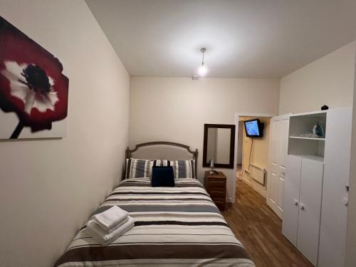 a bedroom with a bed and a television in it at Charming 2-Bedrooms City Centre Apartment in Aberdeen