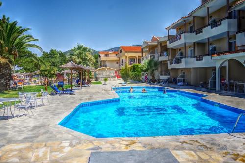 a swimming pool at a resort with people in it at Rachoni Resort in Skala Rachoniou