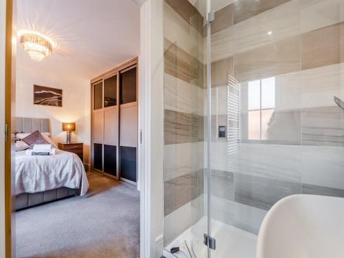 a bathroom with a shower and a bedroom at Number Fifty-Eight in Belper