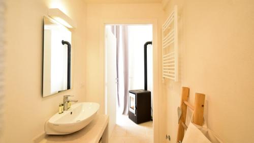 a bathroom with a sink and a mirror at Casa Litali by Rentbeat in Ostuni