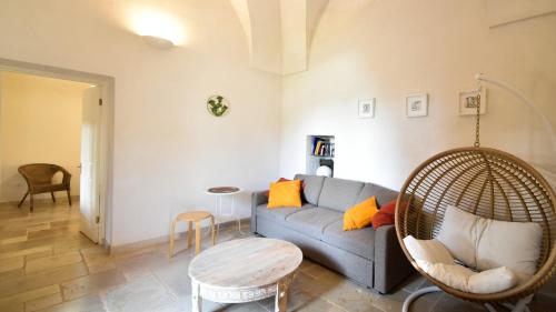 a living room with a couch and a table at Casa Litali by Rentbeat in Ostuni